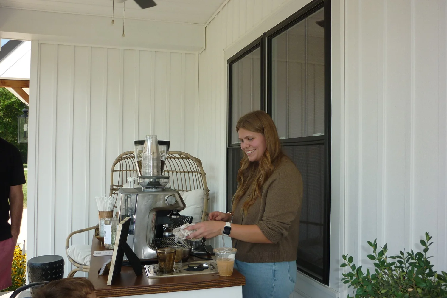 Desi smiling while working behind the Brim Coffee Cart