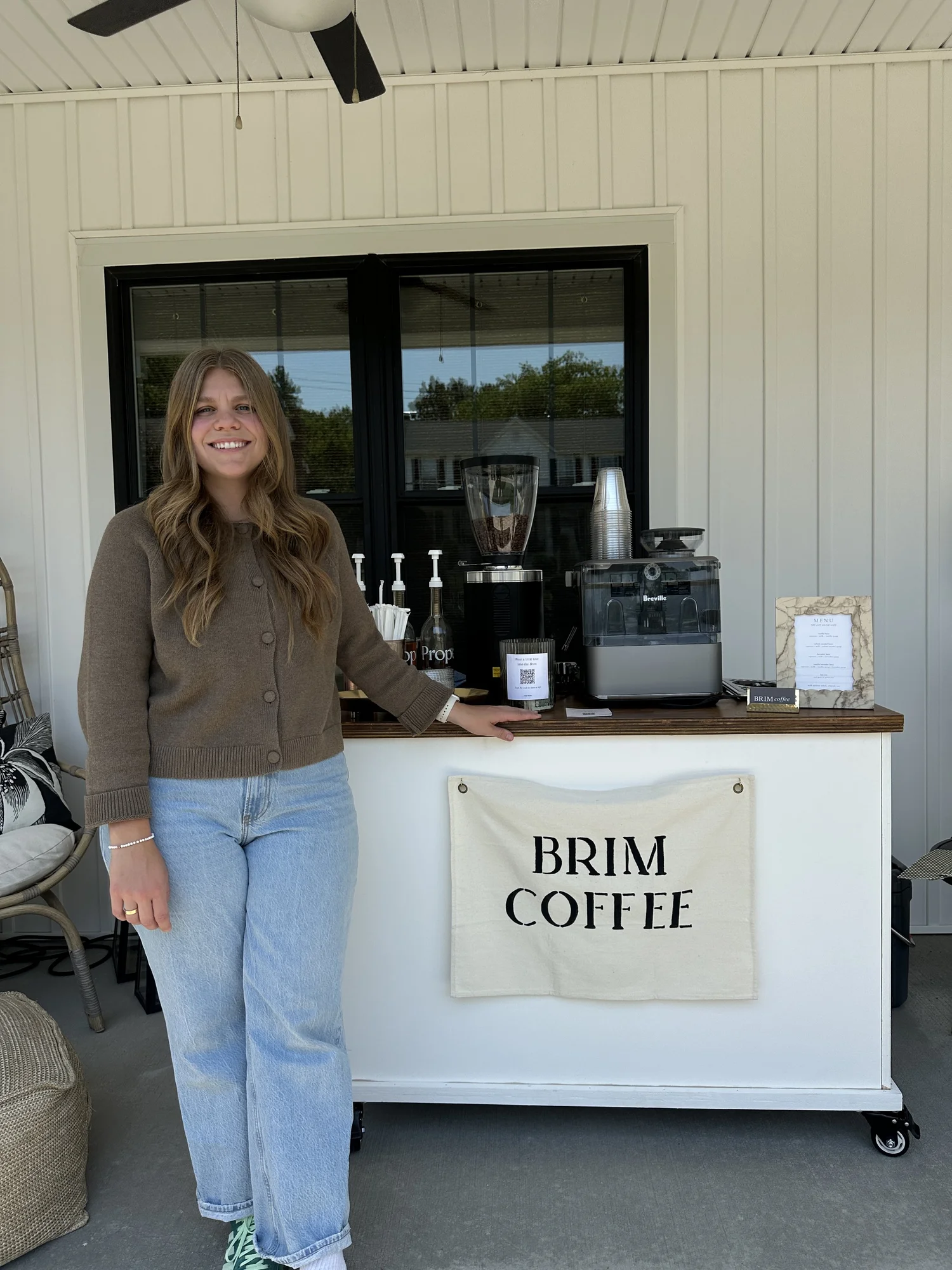Brim Coffee Cart owner standing beside the mobile espresso cart